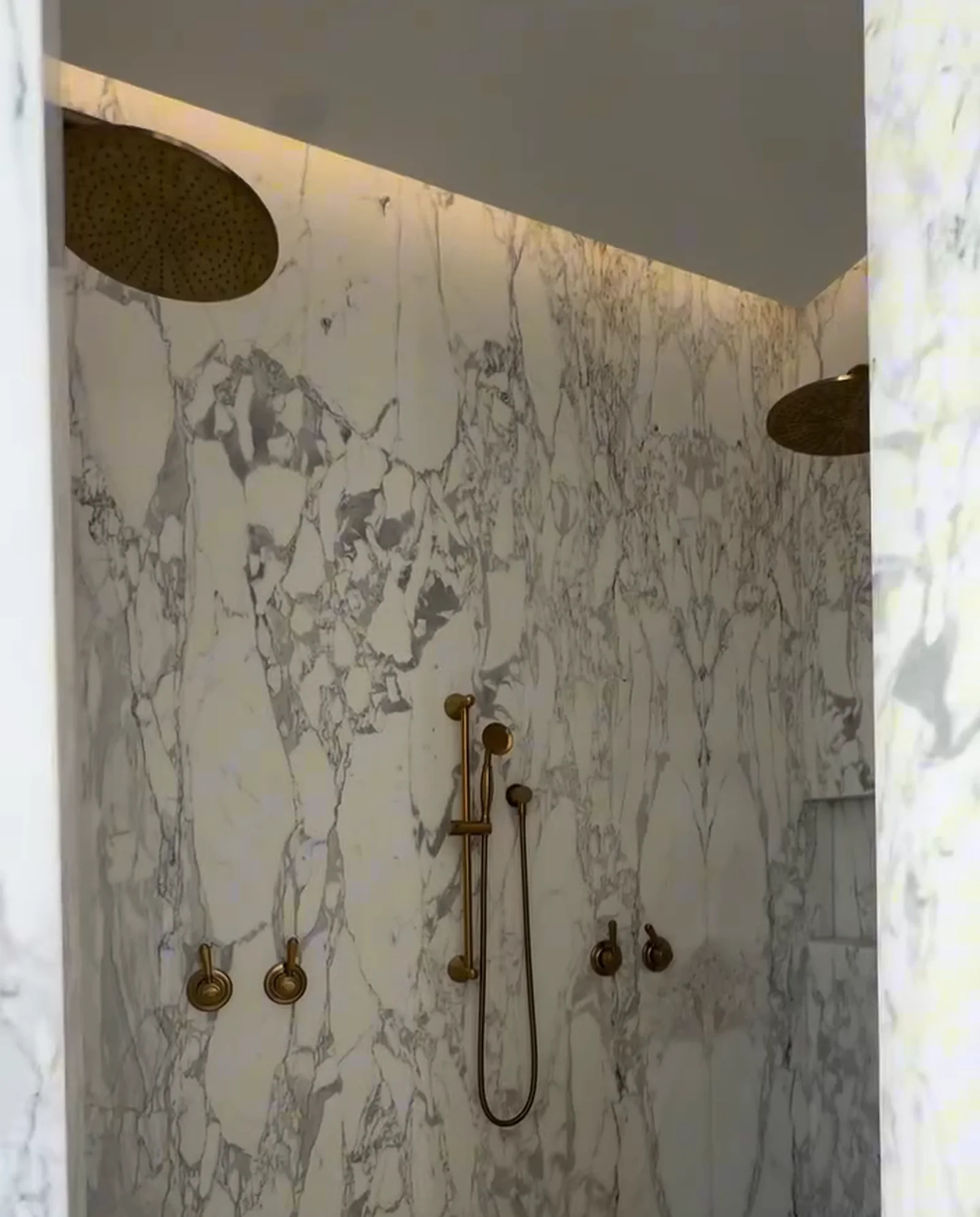 Ensuite in book-matched marble with brass tapware