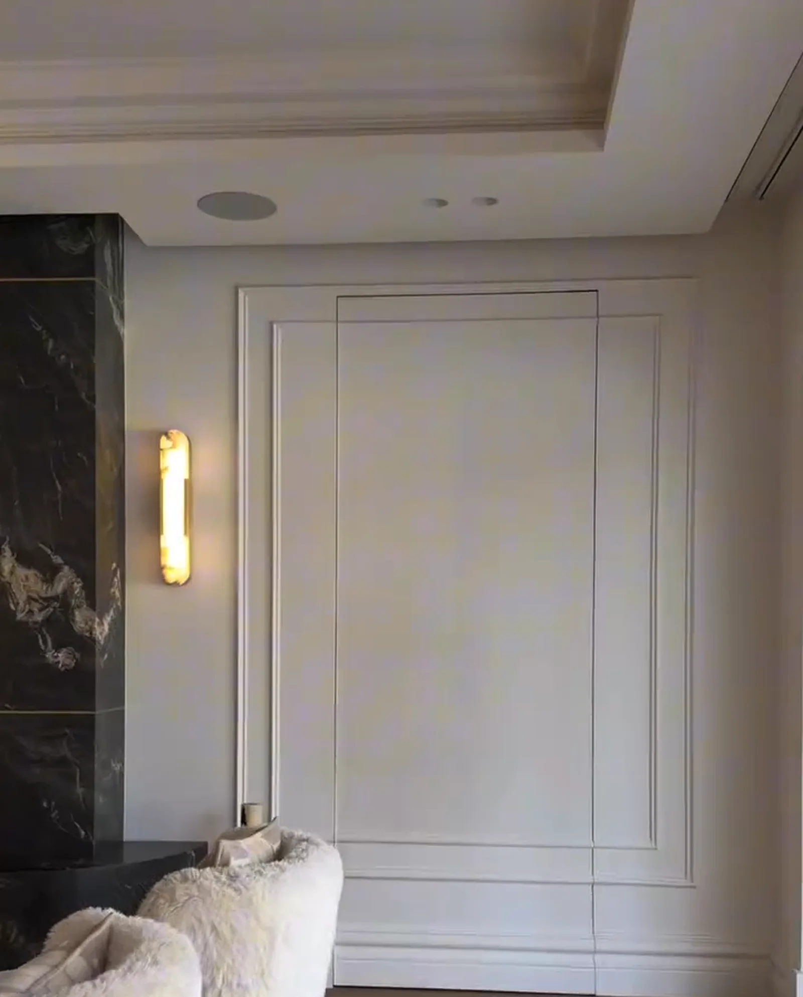 Concealed door set flush into the panelled wall