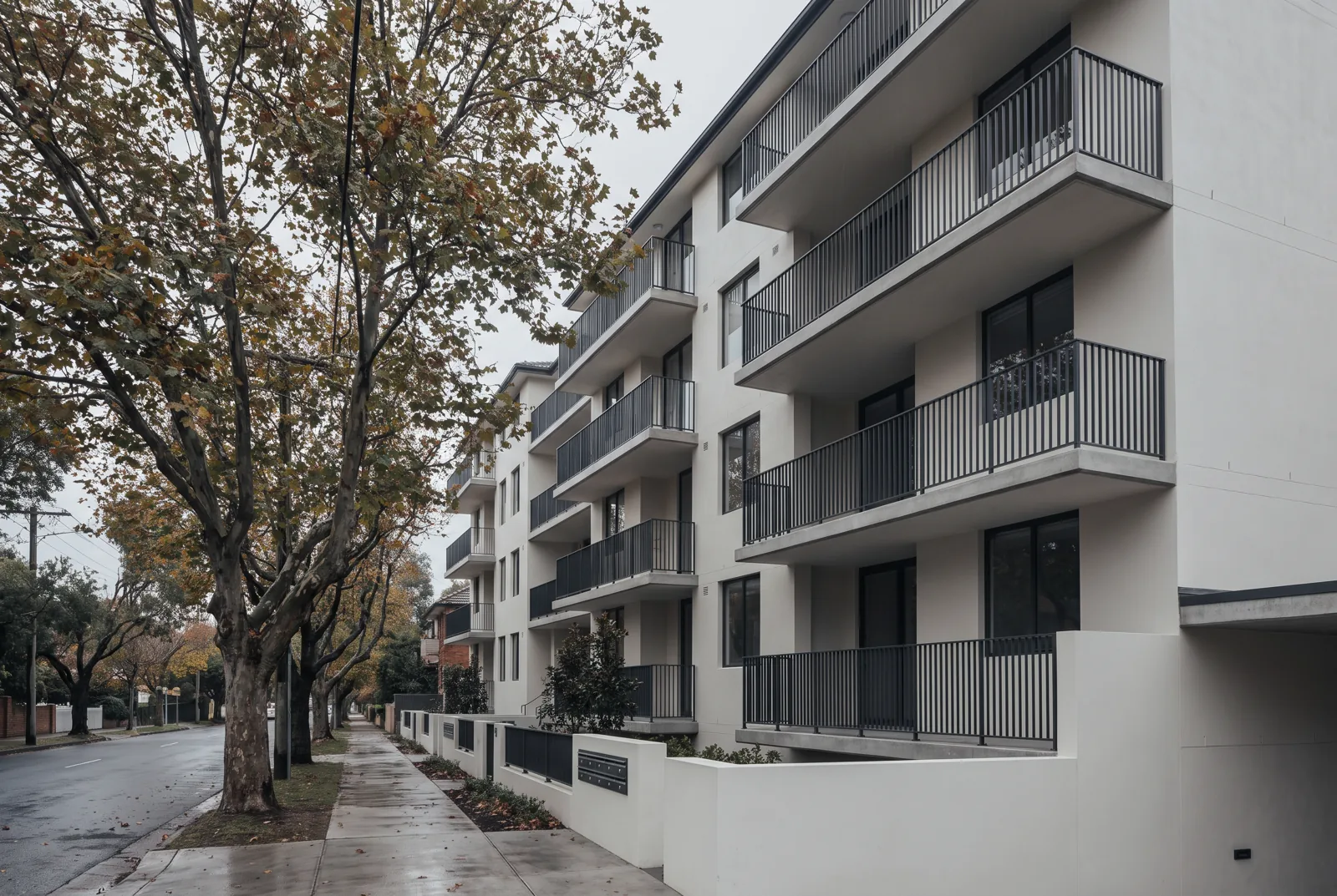 Restored apartment building facade with new render and balustrades